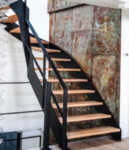 Modern steel staircase with wooden steps in contemporary interior